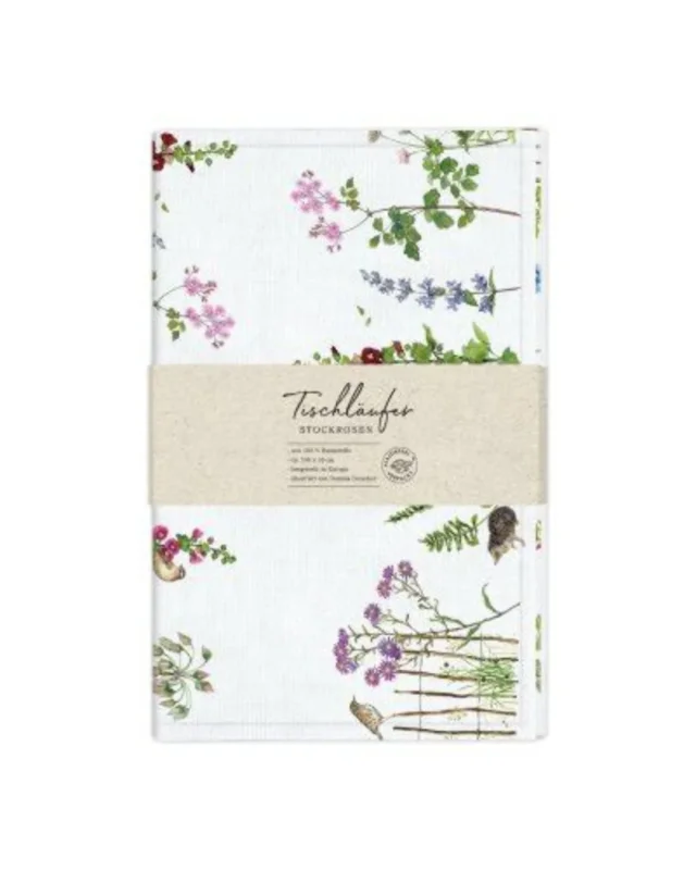 Tischläufer „Stockrosen“ vom Grätz Verlag, gefaltet mit Papierbanderole, florale Stockrosenillustrationen und kleine Katzenmotive, Design von Daniela Drescher