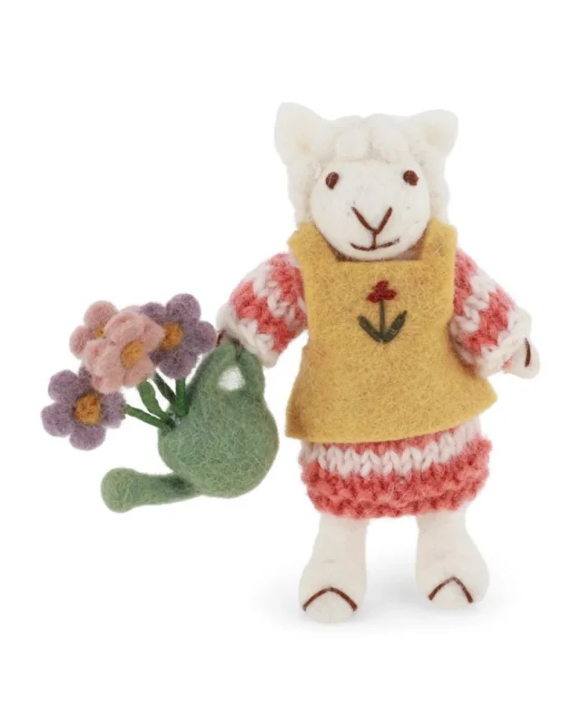 Weißes Schaf als Filzanhänger von Gry & Sif mit gelber Schürze, rotem Rock und grüner Gießkanne mit Blumen vor weißem Hintergrund.